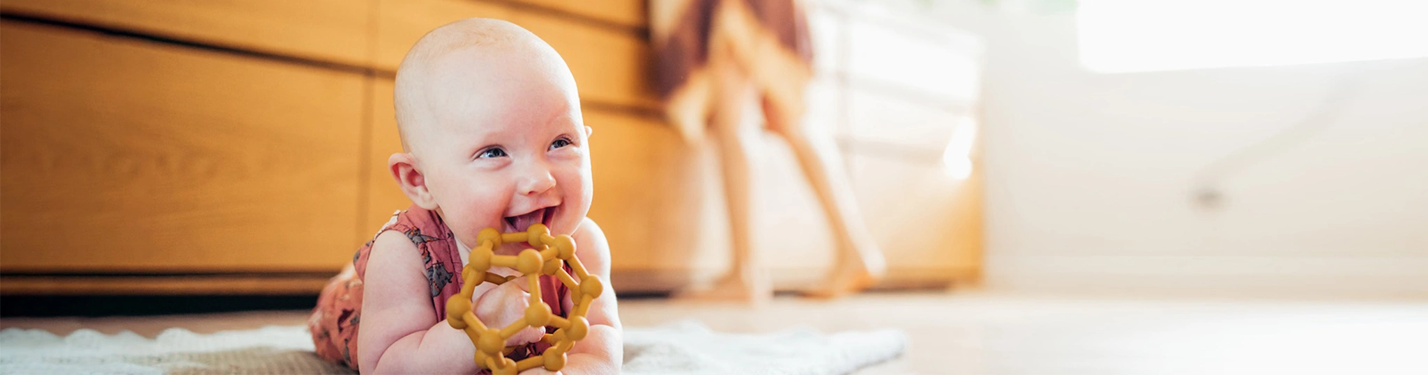 Bambo-nature-baby-laughing-on-floor-1