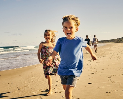 children-running-on-beach-08-2022-1200x630